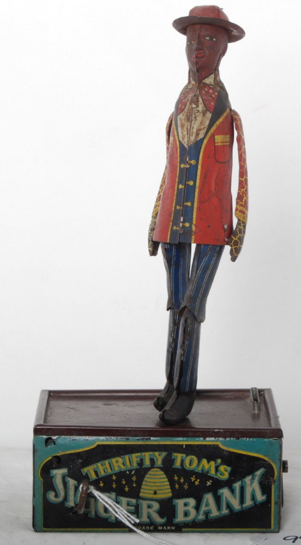 Strauss Thrifty TomÕs Jigger Bank, mechanical toy: The Ferdinand Strauss Corp. Thrifty TomÕs Jigger Bank, lithographed tinplate mechanical windup bank/toy, C6 area dancer with some light surface rust and nicer C7-8 base. Toy should clean and polish n