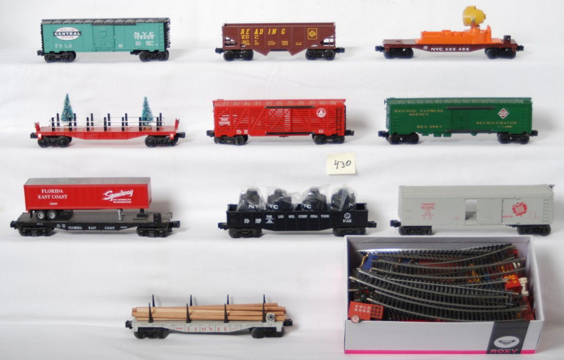 Misc O gauge and HO freight cars: Misc. O gauge and HO train items. Includes unmarked flat with pine trees, 29499 New York Central searchlight car, 6177 Reading hopper, K Line Baltimore and Ohio stock car, 6424 Lionel scout flat, 6462