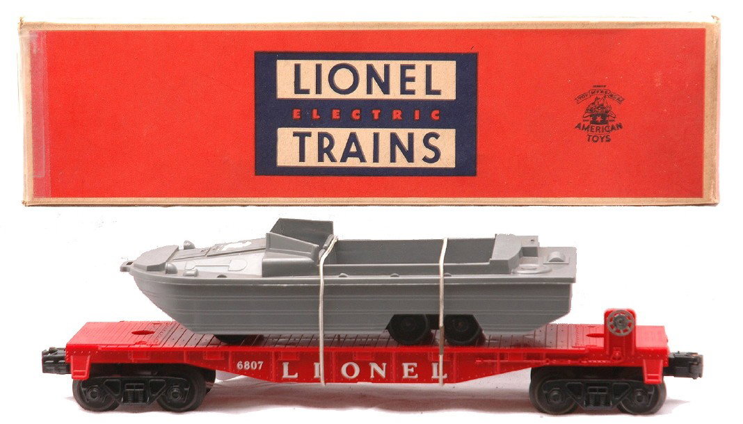 Lionel 6807 Flatcar w/U.S.M.C. Boat Boxed: Lionel postwar 6807 flatcar with U.S.M.C. boat in OB, C8. The OB has all flaps attached with some tape repair.