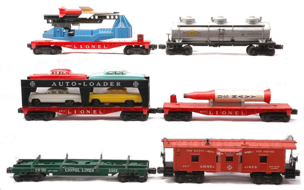 Lionel Freight Cars 3362 6175 6414 6415 6650 6517: Lionel postwar freight cars including; 3362 helium unloading car missing the helium tanks, 6175 red flatcar with rocket that has been repaired, 6414 Evans auto loader with four cars, 6415 silver Sunoc