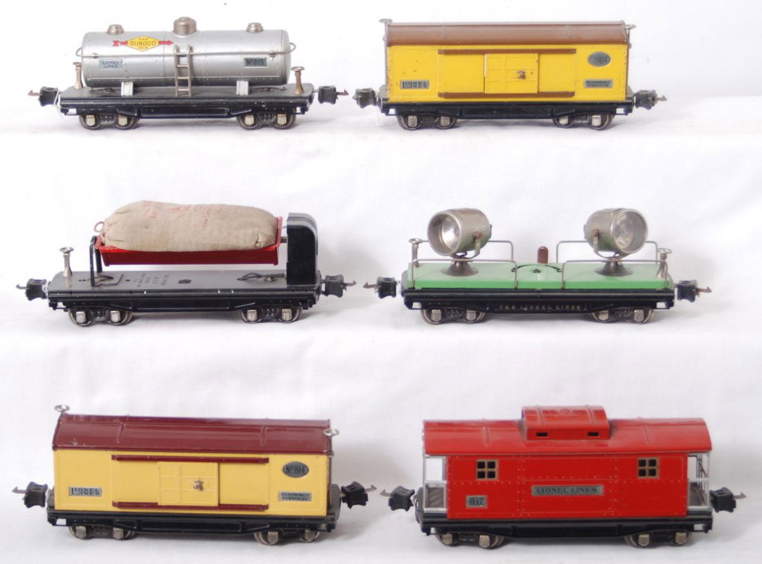 Lionel 814, 814, 815, 817, 820, 3859, 206: Prewar Lionel O gauge two 814 automobile furniture boxcars (one missing coupler key), 815 Sunoco tank, 817 caboose, 820 searchlight car, 3859 automatic dump car with a 206 bag of artificial coal, C6-7
