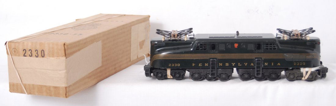 Beautiful Lionel 2330 Pennsylvania GG-1 in OB: Postwar Lionel O gauge No. 2330 Pennsylvania 5-stripe GG-1 electric locomotive in original box with insert. Loco looks fantastic C8 area. Box looks C9 area.