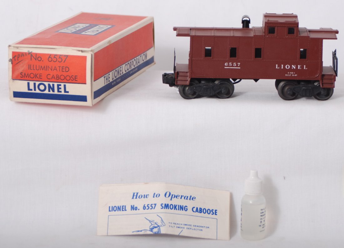 Lionel 6557 illuminated smoke caboose in OB: Postwar Lionel O gauge 6557 left side numbers variation, illuminated smoke caboose in original box with instructions sheet and smoke bottle 909. Caboose is clean C8. Box has inner tape repairs to tuck