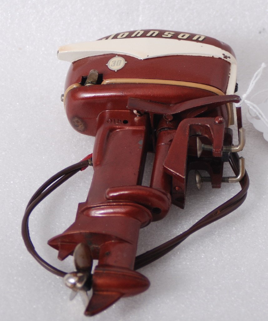 1956 Johnson RD-18 30hp battery op. outboard moto: 1956 Johnson RD-18 30hp battery operated outboard toy boat motor, C7. Also present and included but not photographed is a custom made acrylic stand similar to the stand in Lot 565 of the Friday sessio