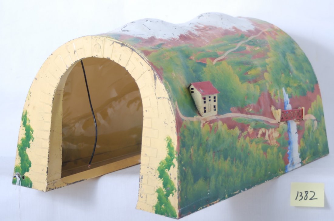 Lionel standard gauge illuminated tinplate tunnel: Prewar Lionel standard gauge tinplate (metal) tunnel, approximately 16-3/4 inches long, 12 inches wide, and 10 inches tall. Nice clean, shiny, and bright C6. One house/chalet is missing a chimney.