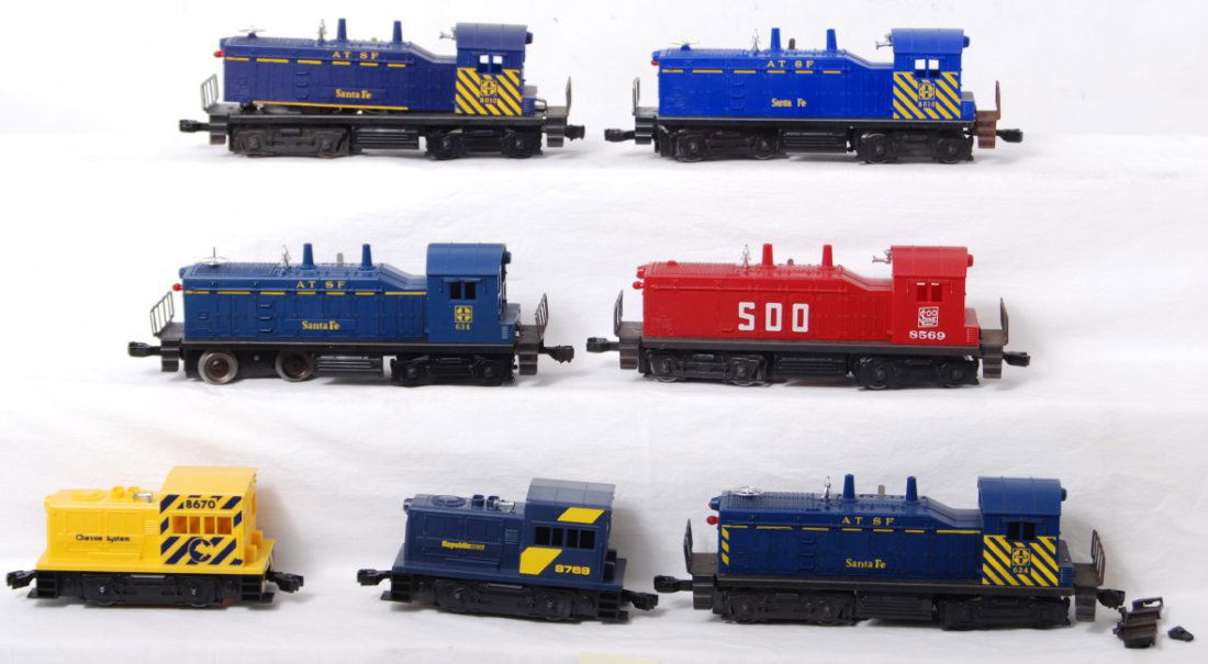 7 Lionel switchers 634, 8569, 8670, etc: Lionel modern O gauge switchers. Seven include 634 Santa Fe, 8670 Chessie, 8769 Republic Steel, 8569 Soo, two 8010 Santa Fe, and one 634 Santa Fe with safety stripes. C6-7.
