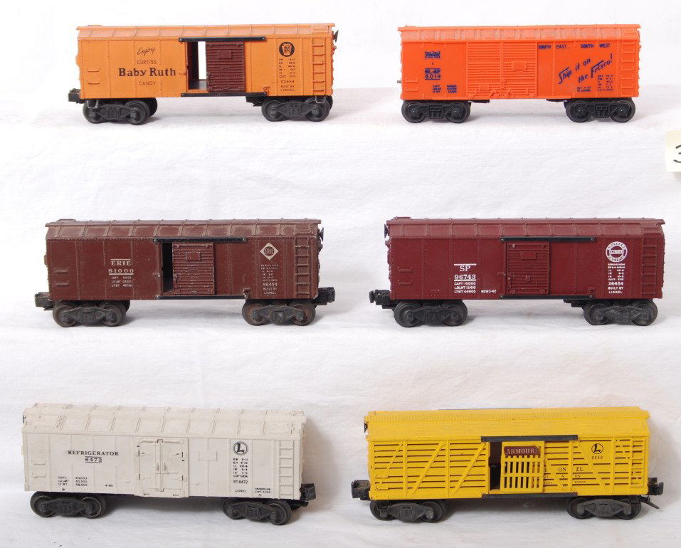 Lionel X2454, 6014, X6454, X6454, 6472, 6656: Postwar Lionel O gauge X2454 Pennsylvania Baby Ruth boxcar, 6014 Frisco boxcar, X6454 Erie (chipped catwalk end) and Southern Pacific boxcars, 6472 reefer, and 6656 Armour stock car. Trains should cle