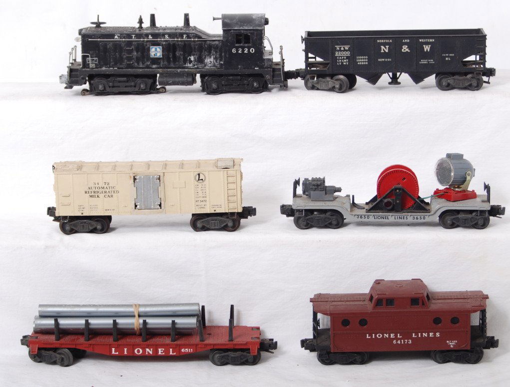 Lionel 6220, 6511, 3472, 3650, 3456, 6417: Postwar Lionel O gauge 6220 A.T.&S.F. Santa Fe NW-2 diesel switcher, 6511 pipe car, 3472 milk car, 3650 extension searchlight car, 3456 Norfolk and Western operating hopper, and 6417 porthole caboose,