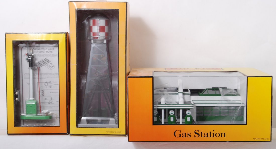 MTH Sinclair gas station, semaphore, water tower: MTH Railking modern O gauge accessories in OBs. Includes 30-9101 Sinclair operating gas station, 30-1075 operating semaphore, and 30-9029 water tower. Items are C8 with some layout use.