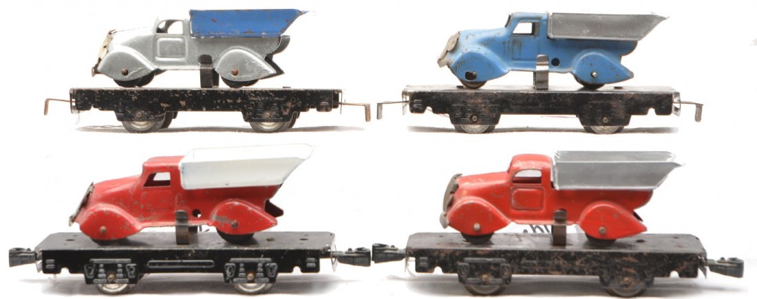 Marx 4-Wheel 4-562 Black Flatcars w/Dump Trucks: Marx four wheel four 562 black flatcars with dump trucks. two with red trucks and repainted beds, one with a blue truck and repainted bed and a repainted truck with a blue bed. The flatcars and trucks