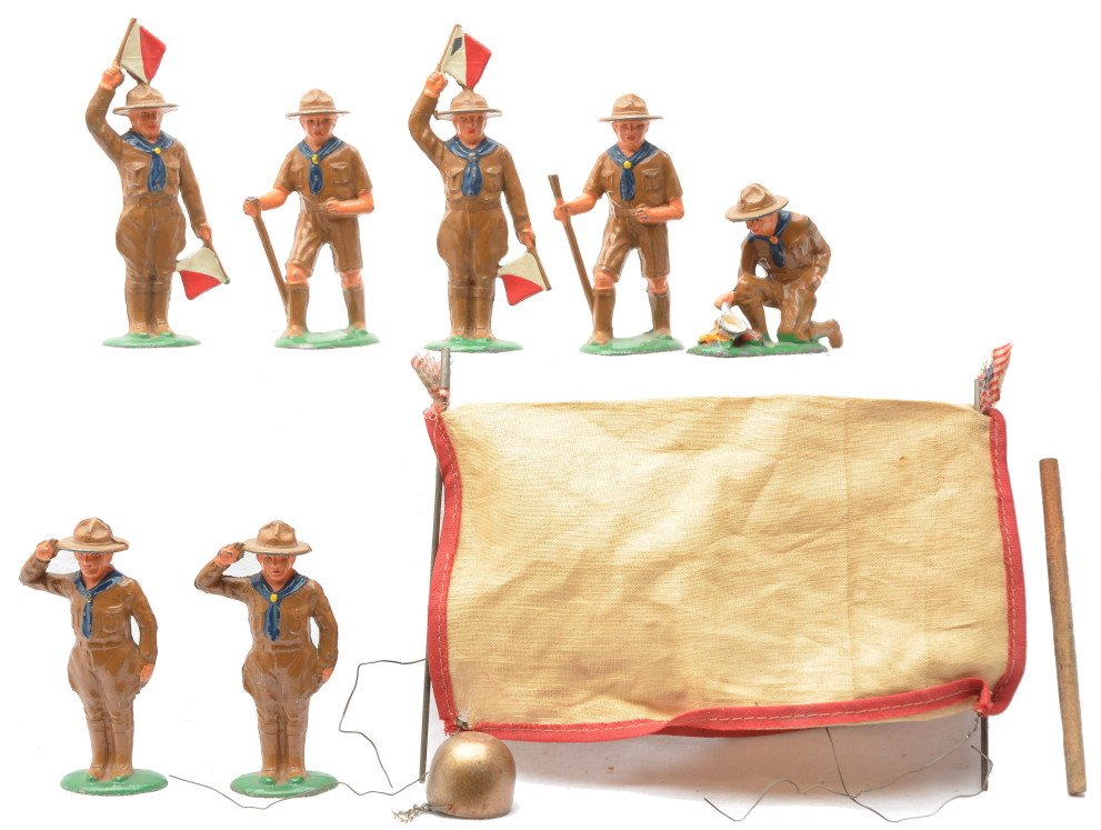 Barclay Selection of Boy Scout Figures: Barclay Boy Scout figures including; two walking with stick, one lighting fire, two saluting and two with flags. Also included is a worn canvas tent and pot for fire. The figures have minor paint loss