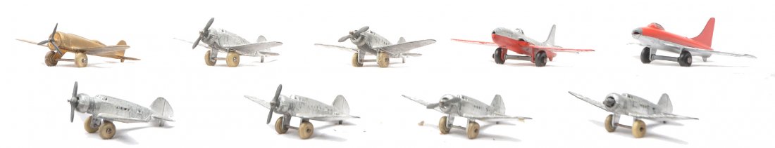 Barclay 6 US Army and TootsieToy Airplanes: Barclay six U.S. Army airplanes with single engine propellers. One airplane has a broken propeller. Also included are three TootsieToy airplanes. The airplanes have moderate paint loss.