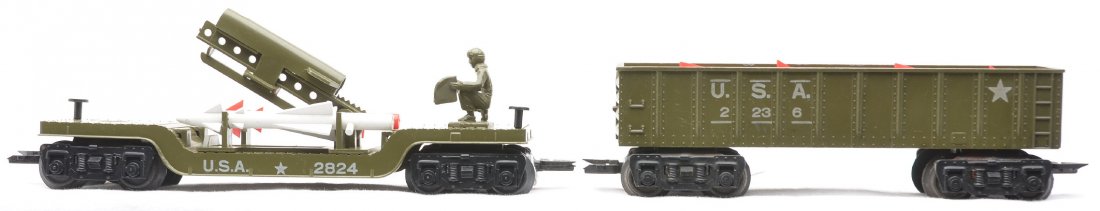 Marx Olive Drab 8-Wheel US Army 2236 2824: Marx olive drab eight wheel U.S. Army 2236 gondola with a reproduction load and a 2824 rocket launcher with rockets. The 2236 is C6 and the 2824 is C7-8.