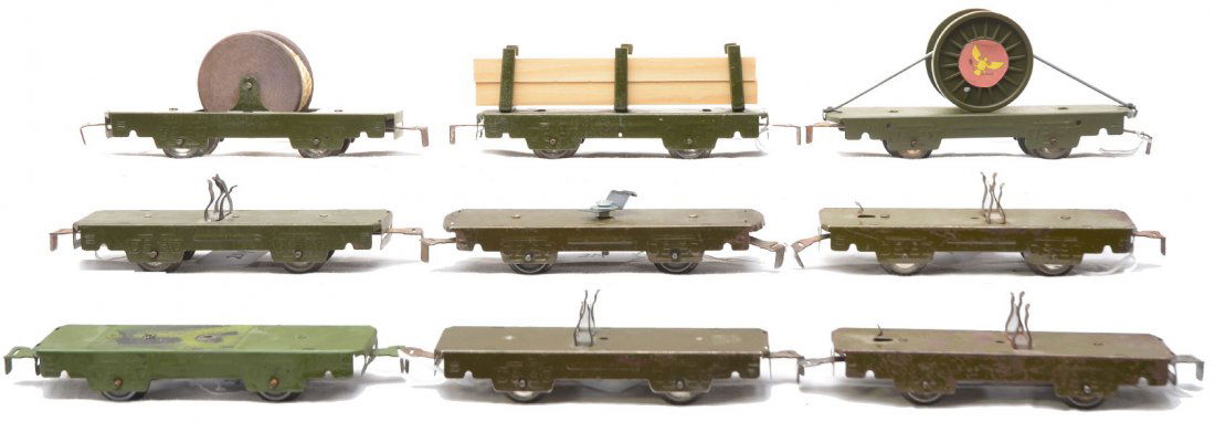 Marx 3 566 Flatcars & Six Olive Drab Flatcars: Marx four wheel flatcars; 566 with a wooden cable reel, 563 lumber car and a 566 flatcar modified with a reel that has plastic cable. All of the flatcars have been painted olive drab. Also included ar