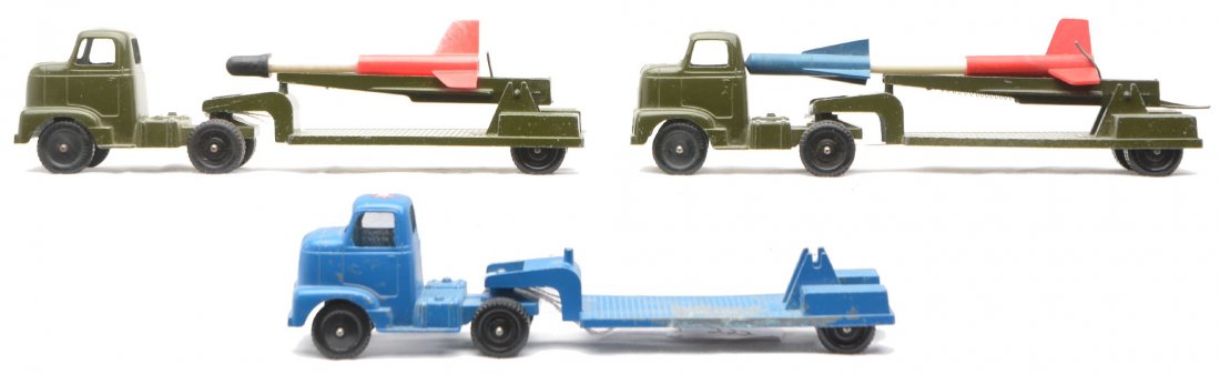 TootsieToys Trucks w/Rocket Launcher Trailers: TootsieToys military semi trucks with rocket launcher trailers; one blue and two olive. The blue trailer is missing the launcher mechanism. Also included are two rockets. The trucks and trailers are C