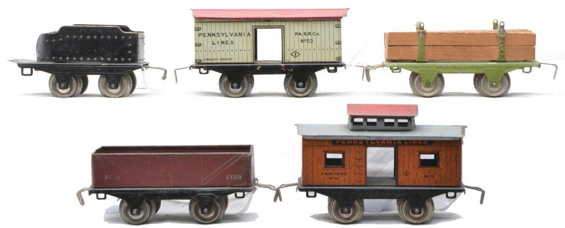 Ives 4-Wheel Litho Freights 53 54 57 56 11: Ives prewar O gauge four wheel lithographed freight cars including; 53 white Pennsylvania Lines merchandise car with a red roof, 54 maroon gravel car, 57 green lumber car with wood load and a 56 orang