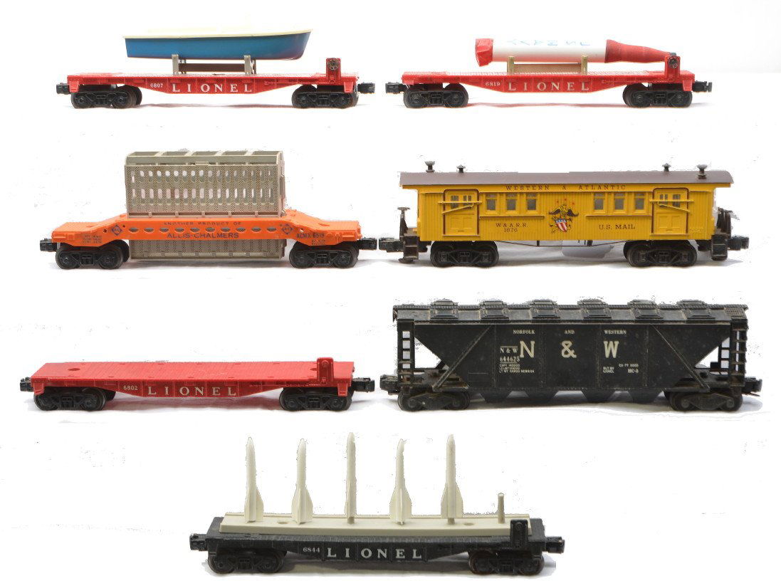 Lionel 6446-25 6819 6807 6519 6802 6844 1876: Lionel postwar freight cars including; 6446-25 black Norfolk and Western covered quad hopper with white lettering, 6819 flatcar with US Navy missile that has some damage, 6807 flatcar that has damage