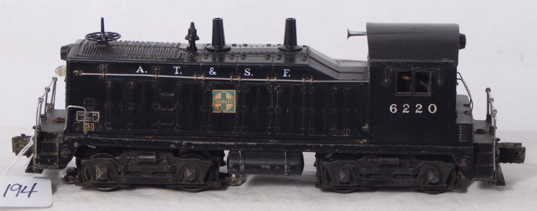 Lionel 6220 A.T.S.F. NW-2 diesel switcher: Postwar Lionel O gauge 6220 A.T.S.F. Santa Fe NW-2 diesel switcher. Two repaired cracks in cab. Please view the photos of the items in this lot, the items are sold as is shown with no returns.