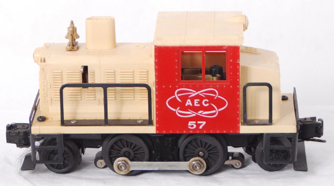 Lionel 57 Atomic Energy Commission diesel switcher: Postwar Lionel O gauge 57 AEC Atomic Energy Commission industrial diesel switcher with a cracked shell at rear firemanÕs window, and a tiny chip above engineerÕs rear window, C6 otherwise.