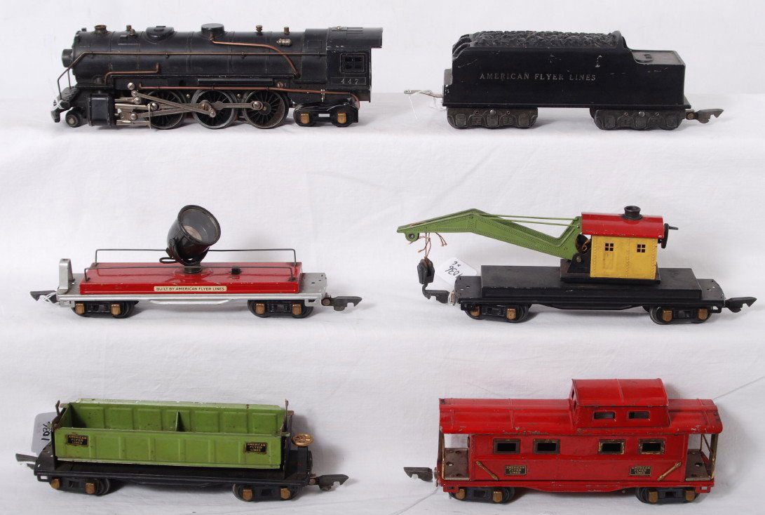 American Flyer 447 loco and tender, four freight: Prewar American Flyer O gauge 447 steam locomotive and tender with dump car, searchlight car, crane car, and caboose, C5-6.