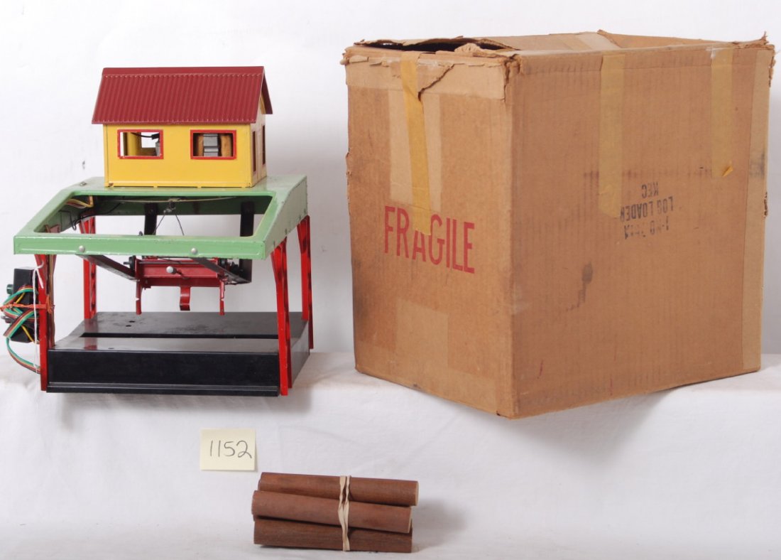 American Flyer No. 751A log loader in OB w/contro: Postwar American Flyer S gauge No. 751A log loader operating accessory with controller and six logs. Loader looks C6. Original box has some old masking tape, pencil writing, some light wear, square an