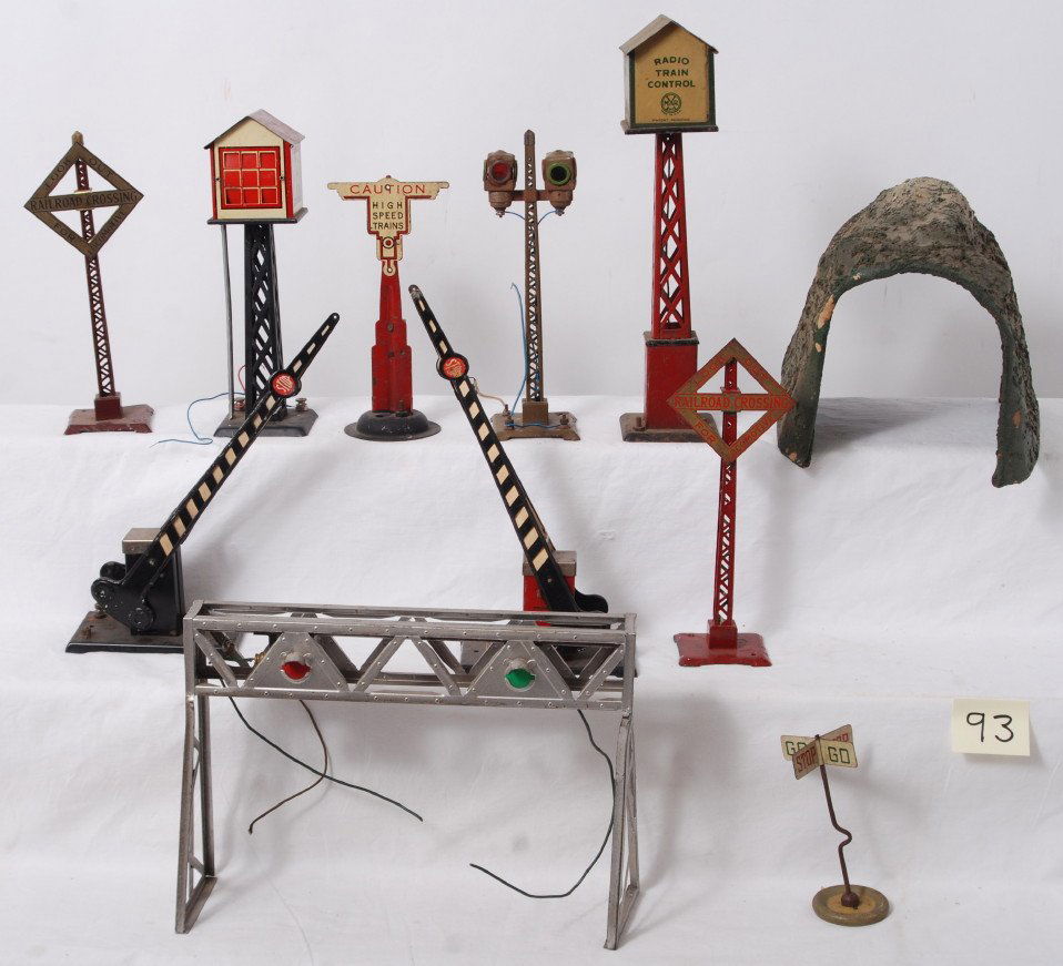 Marx, Lionel, American Flyer O gauge trains: Prewar Marx, Lionel, American Flyer O gauge train accessories, switch towers, crossing gates, crossing signal, overhead signal, tunnel, etc. C5-6. One Lionel Railroad Crossing sign has been repainted.