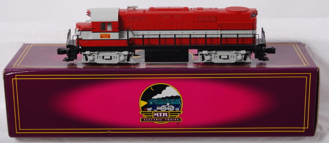 MTH Green Bay Alco RS-27 with Proto: MTH modern O gauge Alco RS-27 loco in OB. Loco is in Green Bay paint. Catalog number is 20-2165-1. Loco features Protosound, Protocouplers, constant voltage headlights and more. Loco is C7-8 with some