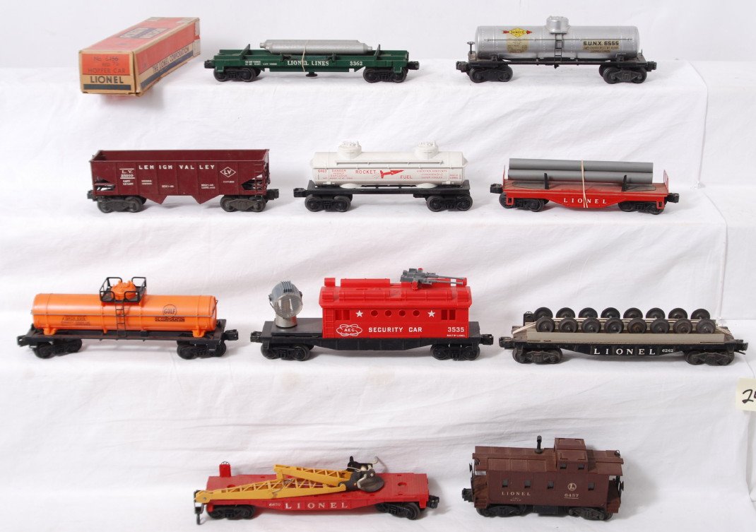 Ten Lionel freight cars, 3535, 6670, 6463, 6262, 3: Postwar Lionel O gauge 3535 AEC security car, 6555 Sunoco tank, 6670 cherry picker, 6262 wheel car, 6315 Gulf tank, unnumbered flatcar w/pipes, 6463 Rocket Fuel tank, 6456 red Lehigh Valley hopper in 