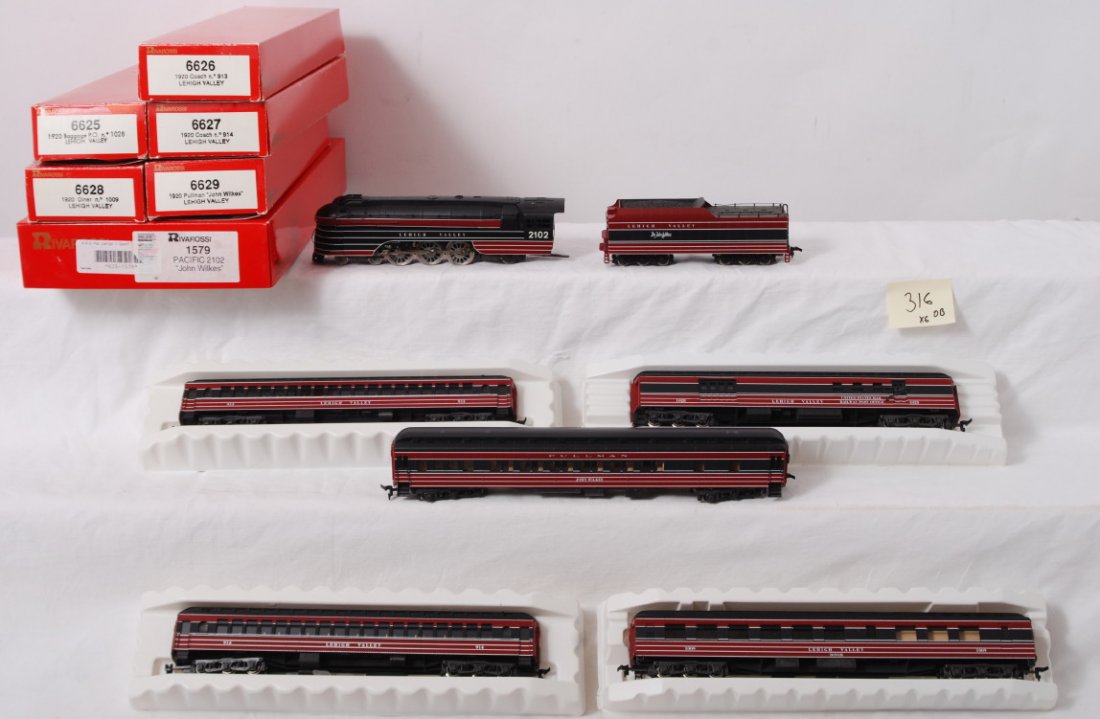 Rivarossi John Wilkes loco and passenger cars: Rivarossi modern HO Lehigh Valley John Wilkes passenger set in OB. Includes 1579 Pacific steam locomotive, 6625 baggage, 6626 coach, 6627 coach, 6628 diner, and 6629 Pullman. Cars and locos are C8.