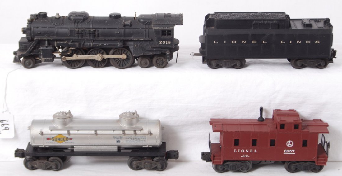 Lionel 2018, tender, 2465, 6357 freight trains: Postwar Lionel O gauge 2018 steam locomotive and unnumbered tender with whistle, 2465 Sunoco tank, and 6357 caboose. Loco is missing a pilot step, otherwise trains range C5 to C7.