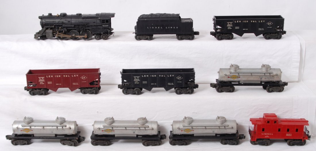 Lionel 2035, 2466WX, 6456 x3, 6465 x4, 6257: Postwar Lionel O gauge 2035 steam locomotive, 2466WX whistle tender, three 6456 Lehigh Valley hoppers, four 6465 Sunoco tank cars, and 6257 caboose missing a step. Trains otherwise look C5-6.