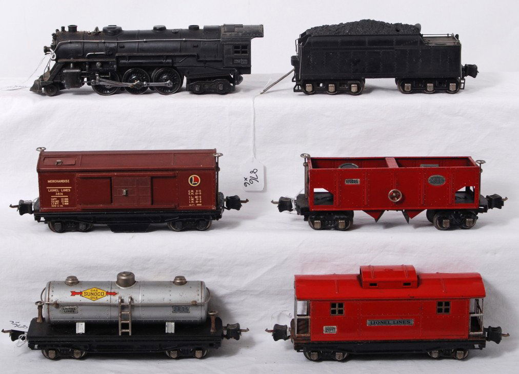 Lionel 226E, 2226W, 3814, 2815, 2816, 2817 freight: Prewar Lionel O gauge 226E steam locomotive and 2226W whistle tender with 3814 automatic merchandise boxcar, 2815 Sunoco tank, 2816 operating hopper, and 2817 caboose. Trains have a small amount of li