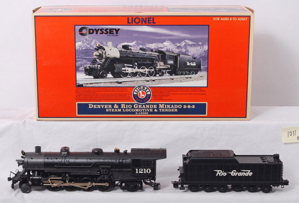 Lionel Rio Grande 18080 Mikado 2-8-2 with TMCC: Lionel modern O gauge 18080 Rio Grande 2-8-2 Mikado in OB. Loco features TMCC, Railsounds, Electrocoupler, fan driven smoke unit and much more. Loco is C8 with run time. Loco box has some light corner