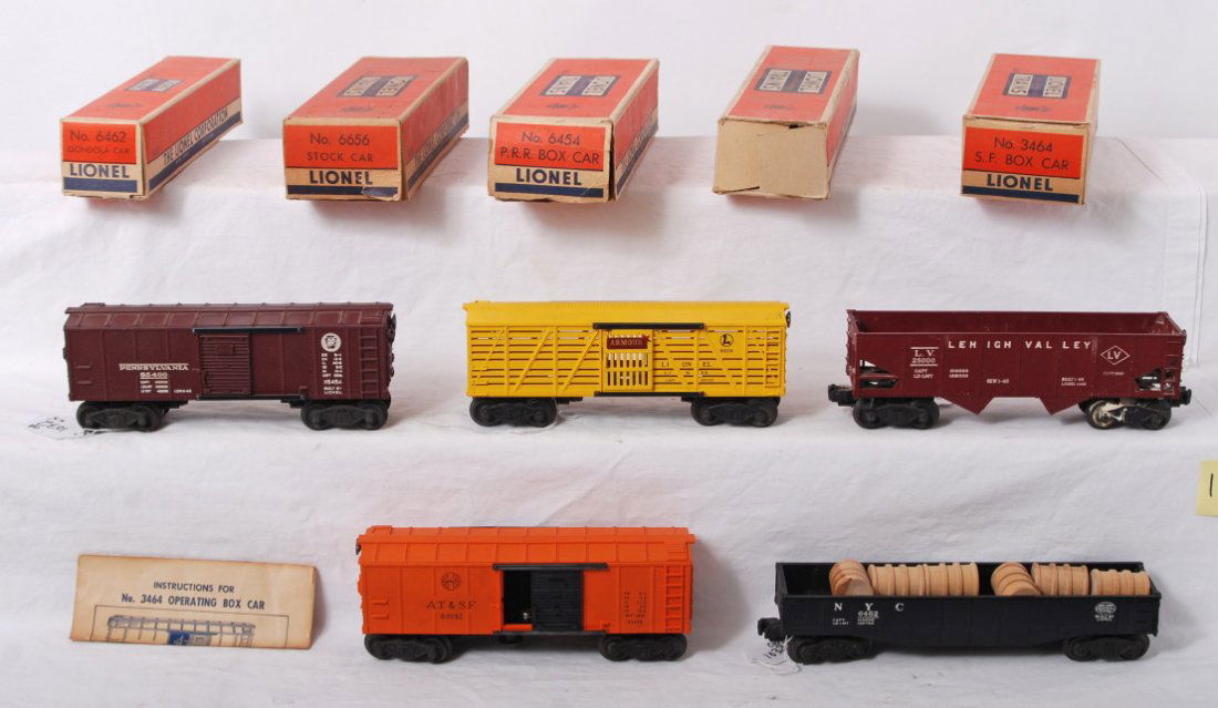 Lionel 6462, 6656, 6454, 3464, 6456 in OB: Postwar Lionel O gauge 6462 NYC gondola, 6656 Armour stock car, 6456 Lehigh Valley hopper, 6454 Pennsylvania boxcar, 3464 A.T.S.F. operating boxcar with insert and instructions sheet. Trains should cl