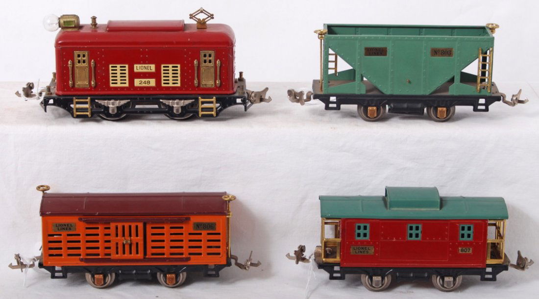 Lionel 248, 803, 806, and 807: Prewar Lionel O gauge 248 electric loco, 803 hopper, 806 stockcar, and 807 caboose, should clean and polish C6-7. Loco wheels have casting fatigue.