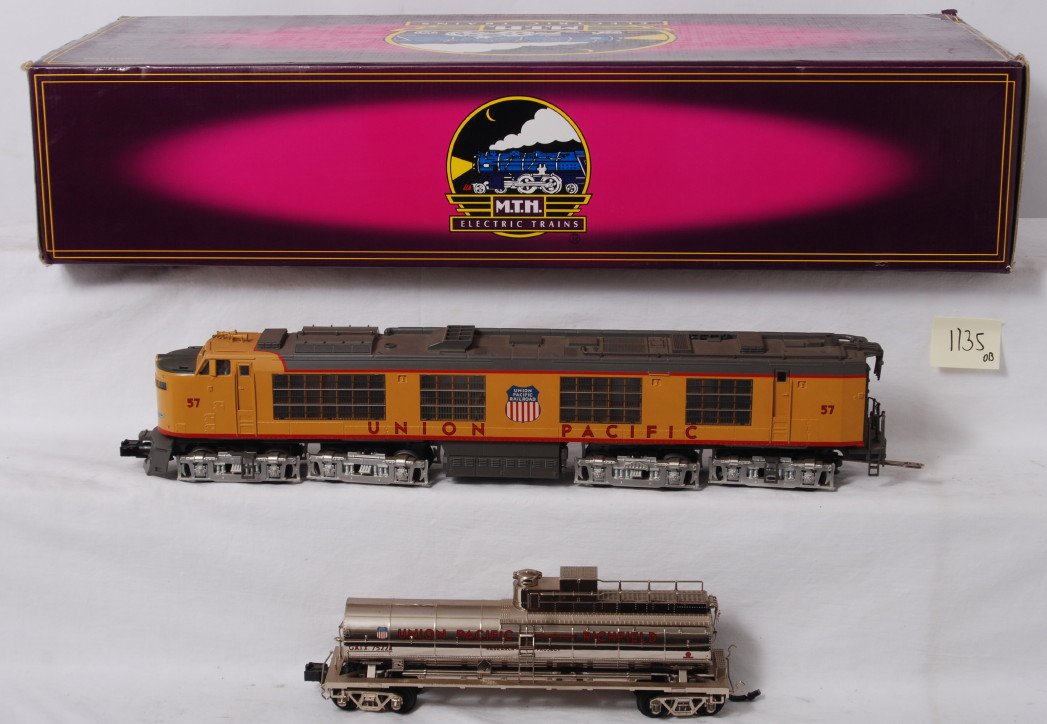 MTH Union Pacific Propane turbine with Proto 2: MTH modern O gauge 20-2261-1 Union Pacific propane turbine in OB. Loco features Protosound 2.0, DCS control, Protosmoke, Protocouplers, and more. Set is C8, tank car could use cleaned. Locomotive orig