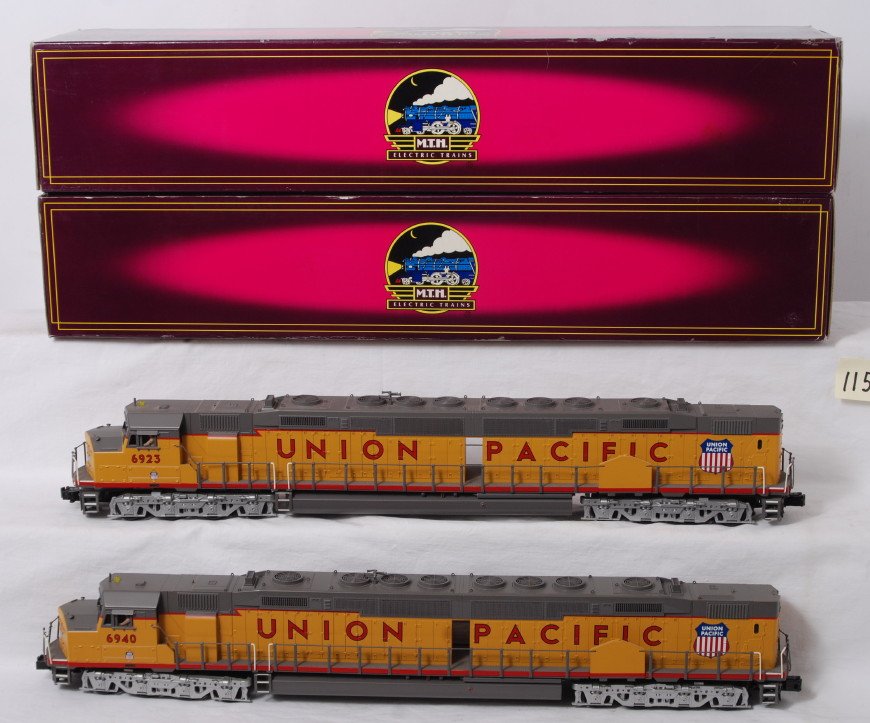 MTH Union Pacific DD40AX pair with Proto 2: MTH modern O gauge 20-2432-1 and 20-2432-3 Union Pacific DD40AX pair in OBs. Powered loco features Protosound 2.0, DCS control, Protosmoke, Protocouplers, and more. Locos are C8, hand rails slightly b