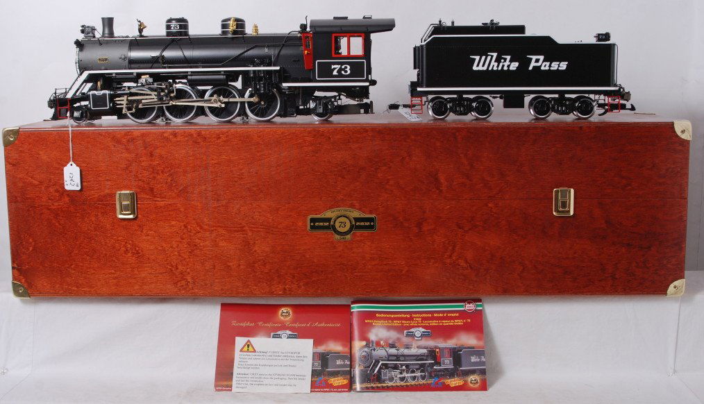 Aster/LGB 21832 White Pass Mikado 73 in OB: Modern era brass/diecast Aster/LGB 21832 White Pass Mikado 73 steam locomotive and tender in original wooden box. Train may have a very small touchup on the back side of the boiler, otherwise train lo