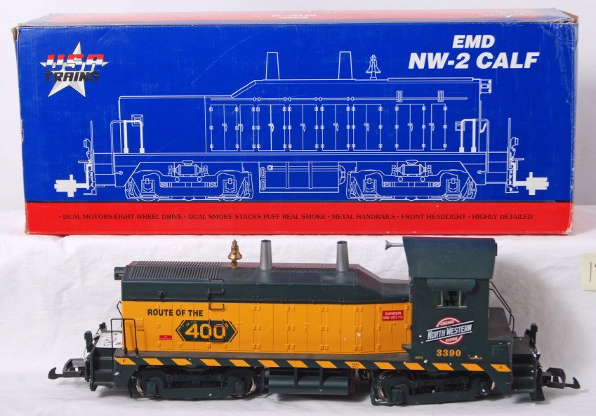USA Trains R22013 C&NW NW-2 diesel in OB G scale: Modern era USA Trains G scale/Gauge 1 R22013 Chicago & North Western NW-2 diesel locomotive switcher in original box with paper literature. Train has broken, bent, and loose trim. Box shows light wear