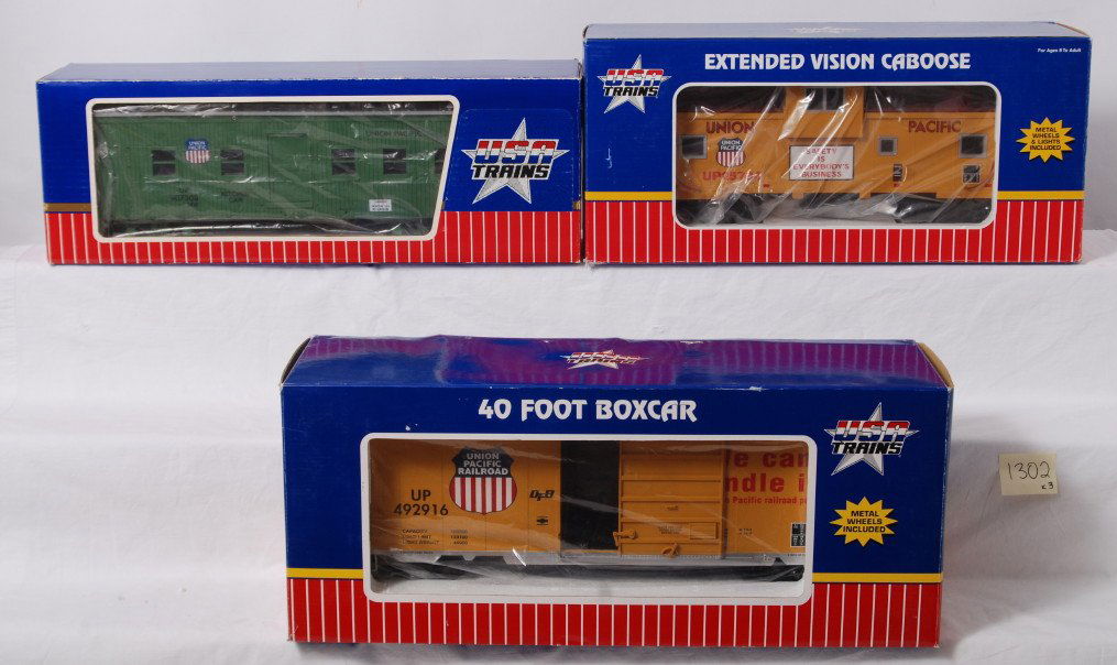 Three USA Trains Union Pacific freight cars in OB: Modern era USA Trains G scale/Gauge 1 freight cars in original boxes, C7-8. R-1844 U.P. kitchen car, R12103 U.P. E.V. caboose 25734 and R19201B U.P. 40Õ boxcar 492916. Boxes show little to light wear