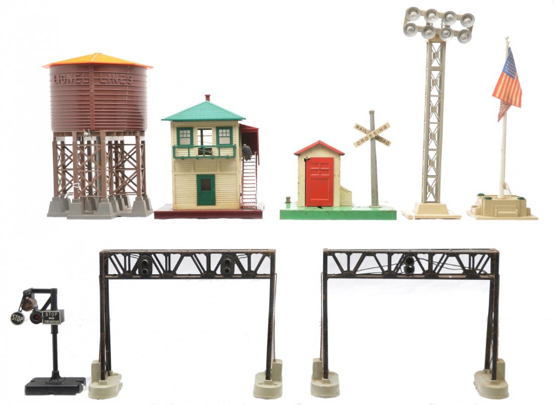 Lionel Accessories 138 450 450 445 89 195 140 45N: Lionel postwar accessories; 138 water tank with cracked tank and detached spout, two 450 signal bridges, 445 switch tower, 89 flagpole, 195 floodlight tower, 140 banjo signal missing the cross buck an
