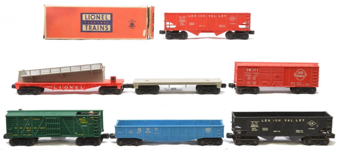 Lionel Freights 6162 6343 6050 6476 6476 3370: Lionel postwar freight cars including; 6162 blue New York Central gondola, 6343 barrel ramp car, 6050 Swift reefer, gray flatcar with no load, 6476 black Lehigh Valley hopper in a worn OB, 6476 red Le