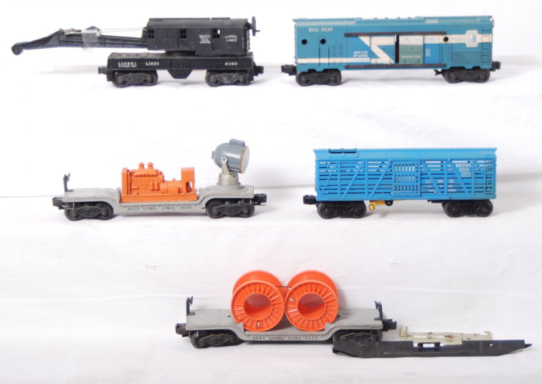 Lionel 3376, 3530, 6460, 3620, 6561: Lionel Postwar O gauge freight cars. Includes 3360 Bronx Zoo car, 3530 GM generator car, 6460 crane with no string, hook detached, 3620 searchlight car, 6561 flat with cable reels. Cars range C5 to C6