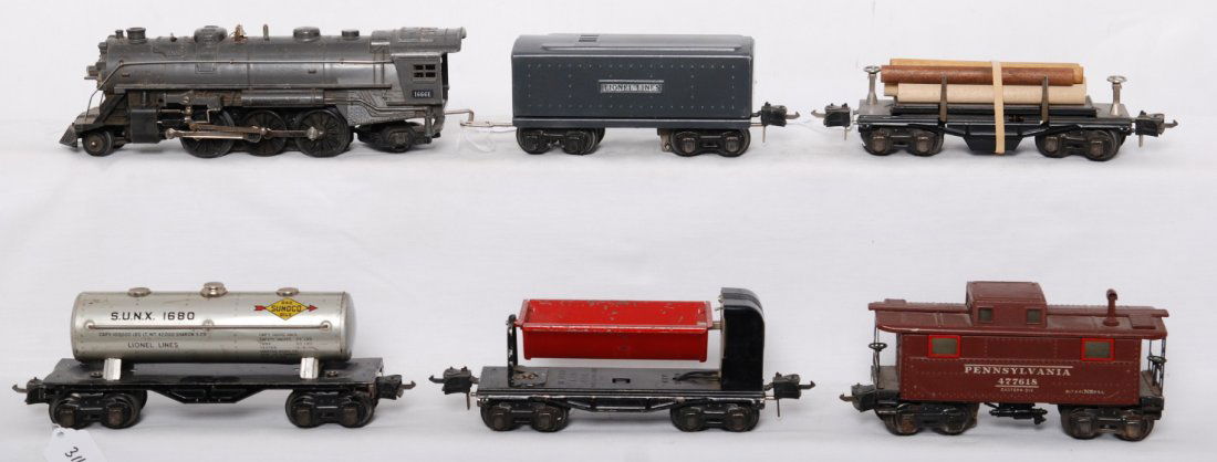 Lionel 1666E, 1689W, 3651, 1680, 3659, 2757: Prewar Lionel O gauge 1666E steam locomotive and 1689W whistle tender with 3651 lumber car, 1680 Sunoco tank, 3659 dump car, and 2757 Pennsylvania caboose, C5-6. Tender is repainted.