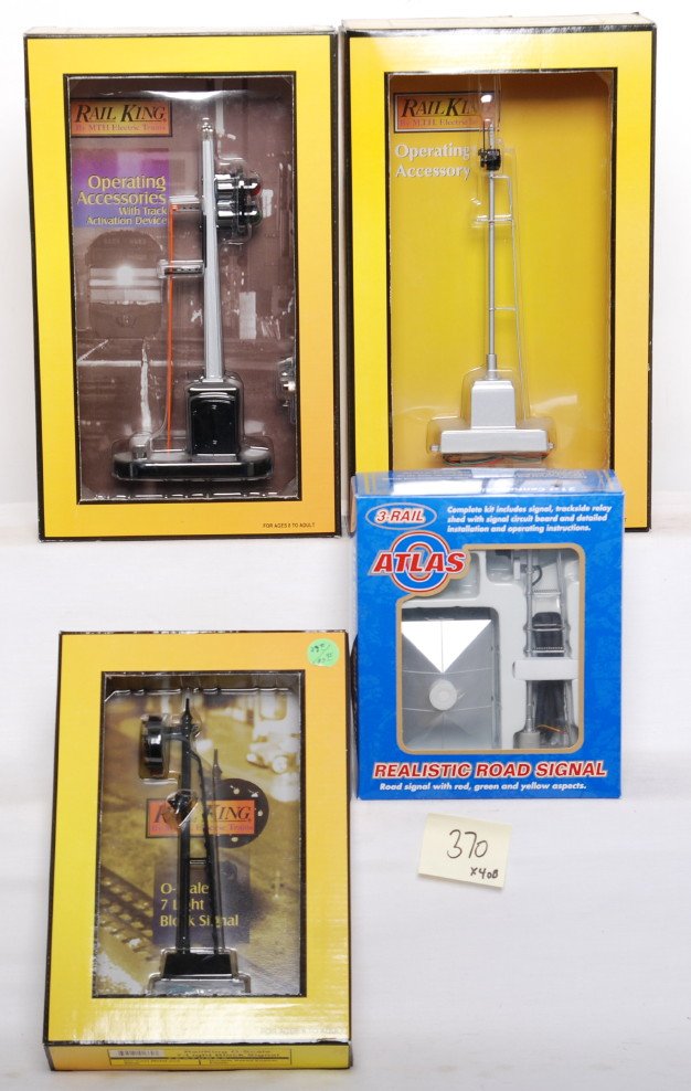 Railking and Atlas O signals: MTH Railking and Atlas O modern O gauge signals in OBs. Includes Atlas 6932 searchlight signal, seven light block signal, 11023 semaphore, and 1076 block signal. C9-10.