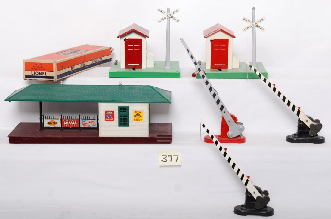 Lionel 152 in OB, 252, 252, 45N, 45N, 256: Postwar Lionel O gauge operating accessories, 152 crossing gate in OB missing flaps, two 252 crossing gates, two repainted 45N watchman, and 256 illuminated freight station with cracked roof, C6-7.