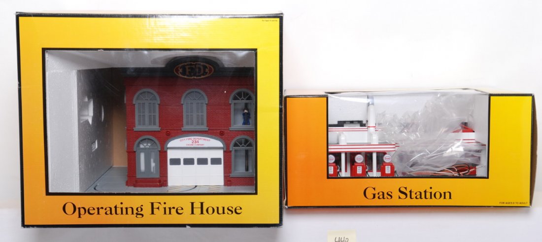 Railking operating fire station and Esso gas stati: MTH Railking modern O gauge operating accessories in OBs. Includes 30-9102 fire house and 30-9106 Esso gas station. Items are C8 with layout use. A few small detail pieces noted missing.
