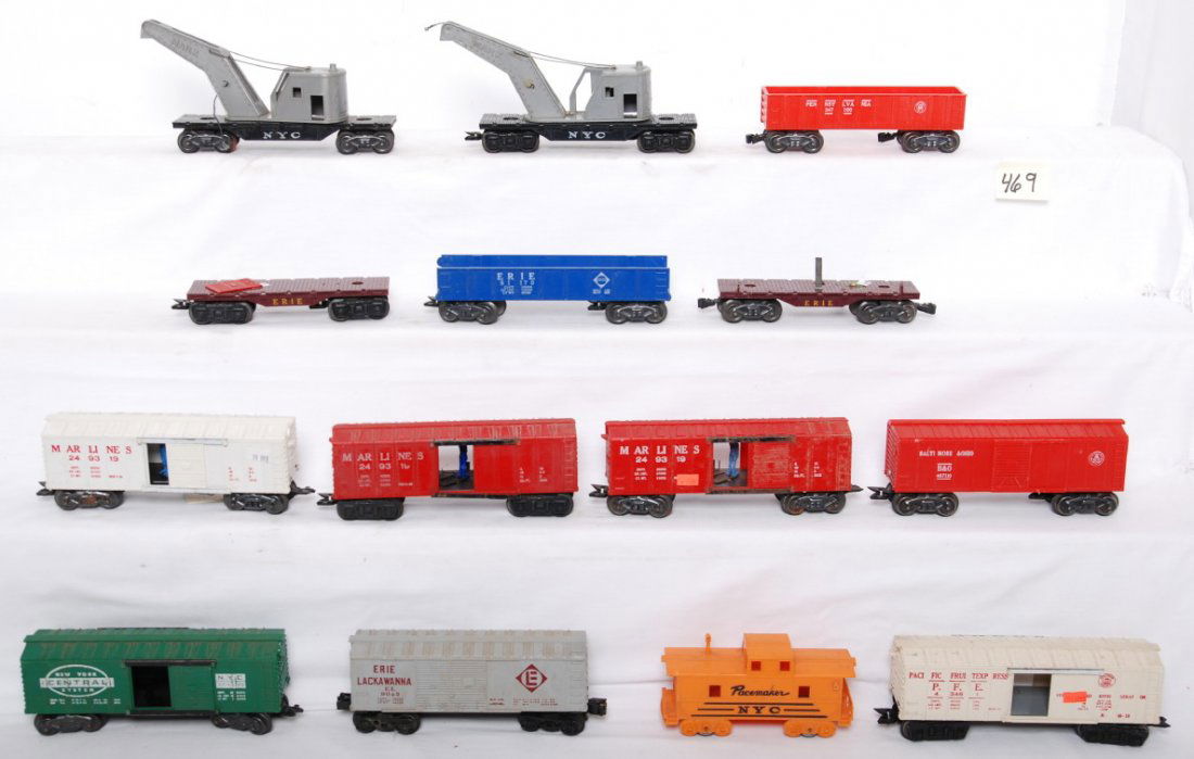 Fourteen Marx O gauge freight cars: Postwar Marx O gauge freight cars with loose door guides, cracked shells, rust, etc. Three 249319 Marlines boxcars (one is white, two red), 467110 B&O boxcar, 9043 Erie Lackawanna boxcar, 17693 NYC bo
