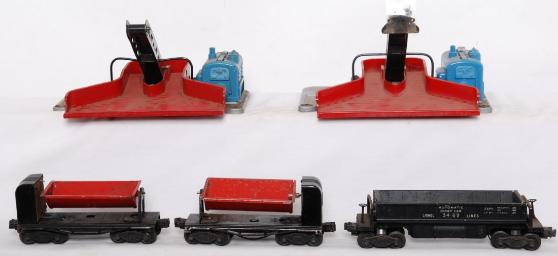 Lionel 397, 397, 3559, 3559, 3469 coal loaders and: Postwar Lionel O gauge 3469 automatic dump car, C6. Two 3559 automatic dump cars, C5-6. Two 397 coal loaders, one is As Is with no returns, for parts. The other 397 is C6 with some light surface rust.