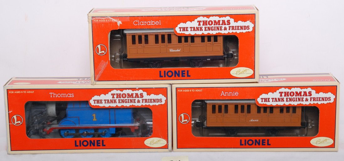 Lionel Thomas the Tank and coaches: Lionel modern O gauge 18719 Thomas The Tank Engine and 15117 and 15118 coaches. Thomas has some small cracks in his faces otherwise trains are C7-8. OBs have some wear.